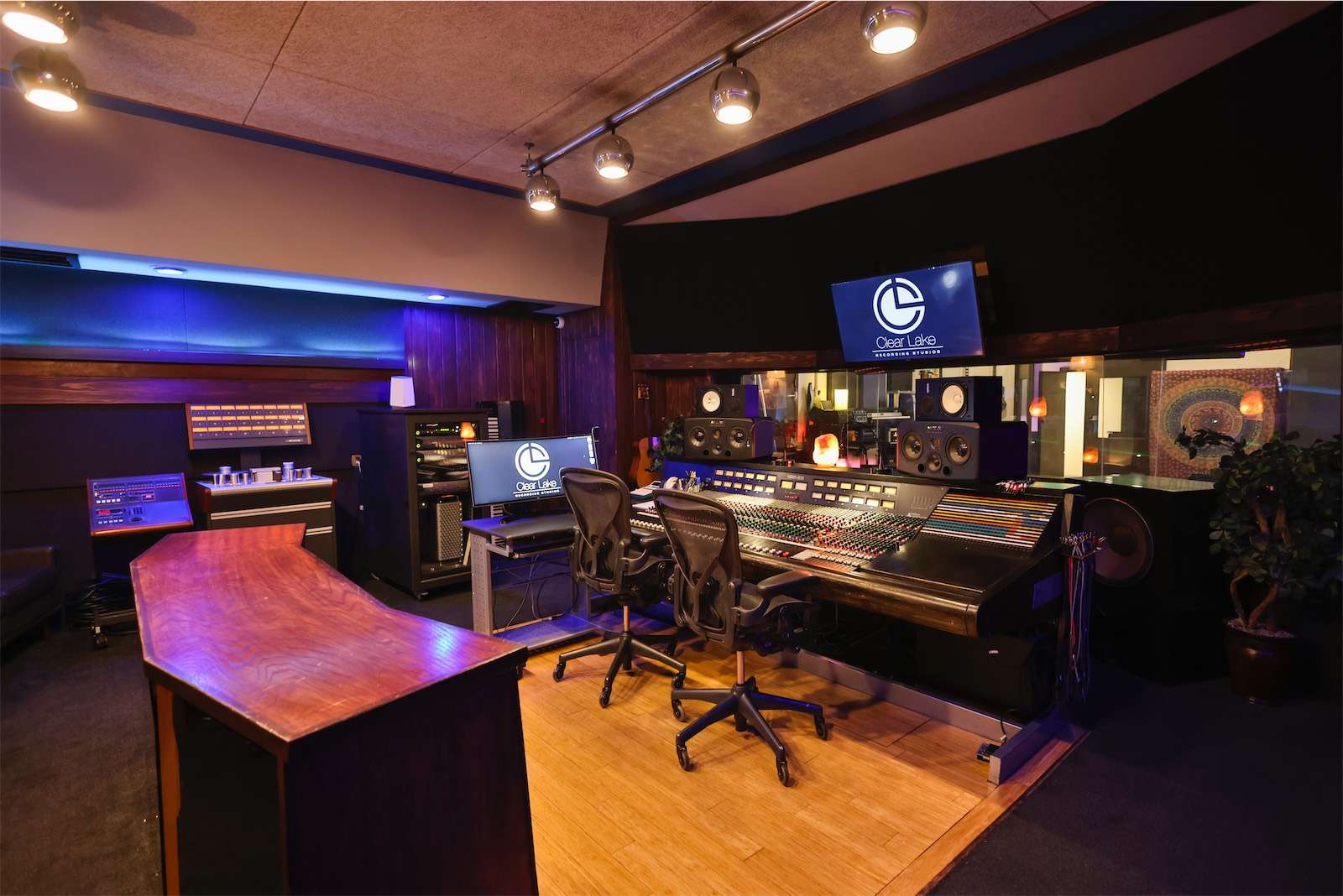 A recording studio with a sophisticated desk and high-quality monitors, located in North Hollywood.
